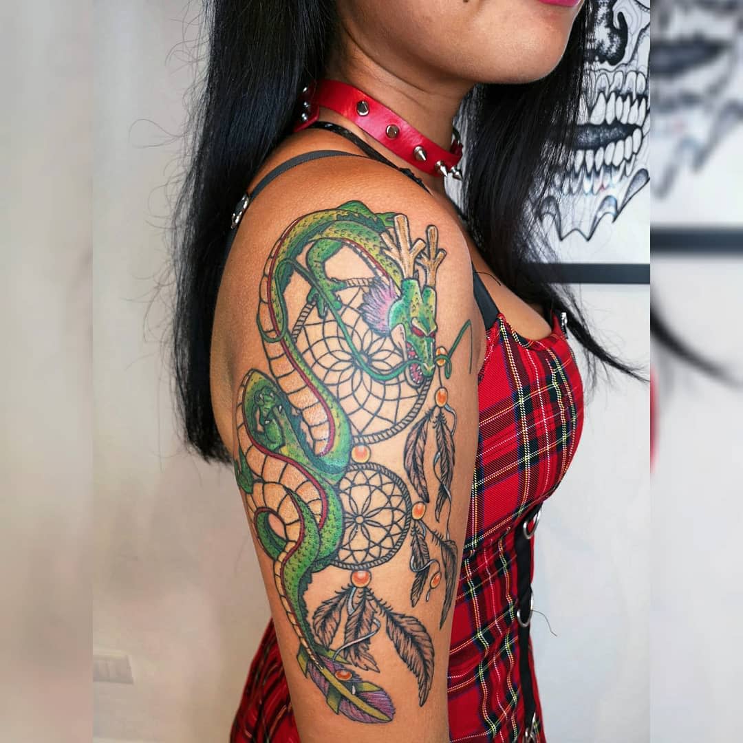 Vibrant Shenron tattoo wrapping around a dreamcatcher, symbolizing protection and dreams