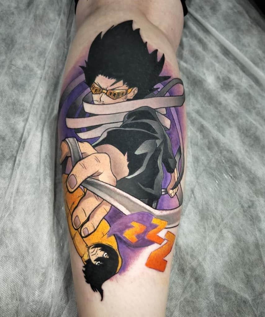 Realistic tattoo of Aizawa from My Hero Academia, shown in his hero costume with goggles and capturing tap swirling around him, alongside a mini version of him lying on a yellow sleeping bag and text with 'ZZZ'