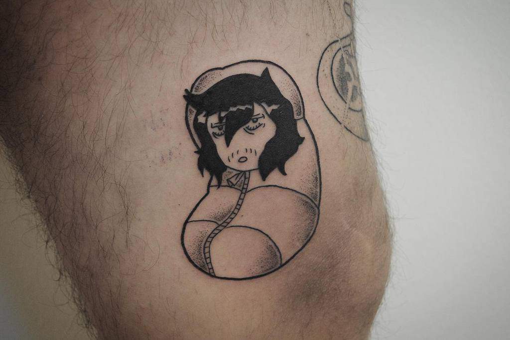 Minimalist black ink tattoo of Shota Aizawa (Eraserhead) from My Hero Academia, depicted as a sleepy, burrito-wrapped character