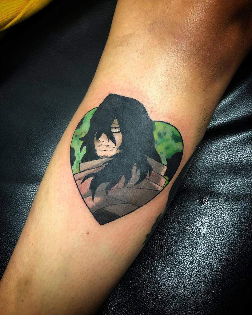 Colorful tattoo of Shota Aizawa (Eraserhead) from My Hero Academia, inside a heart-shaped frame with a green background