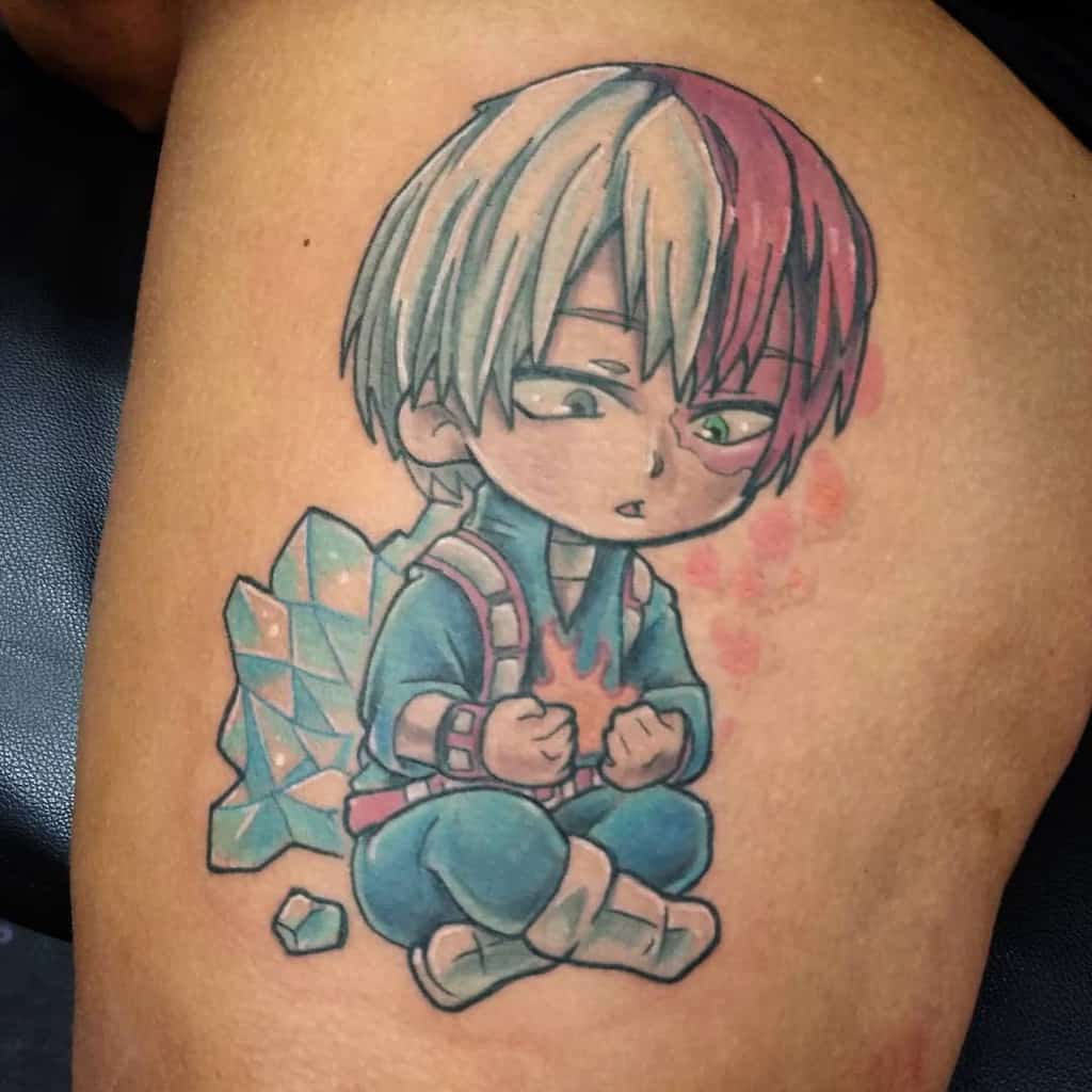 Chibi-style tattoo of Shoto Todoroki from My Hero Academia, sitting with fire in his hands and ice crystals behind him, depicting his dual powers