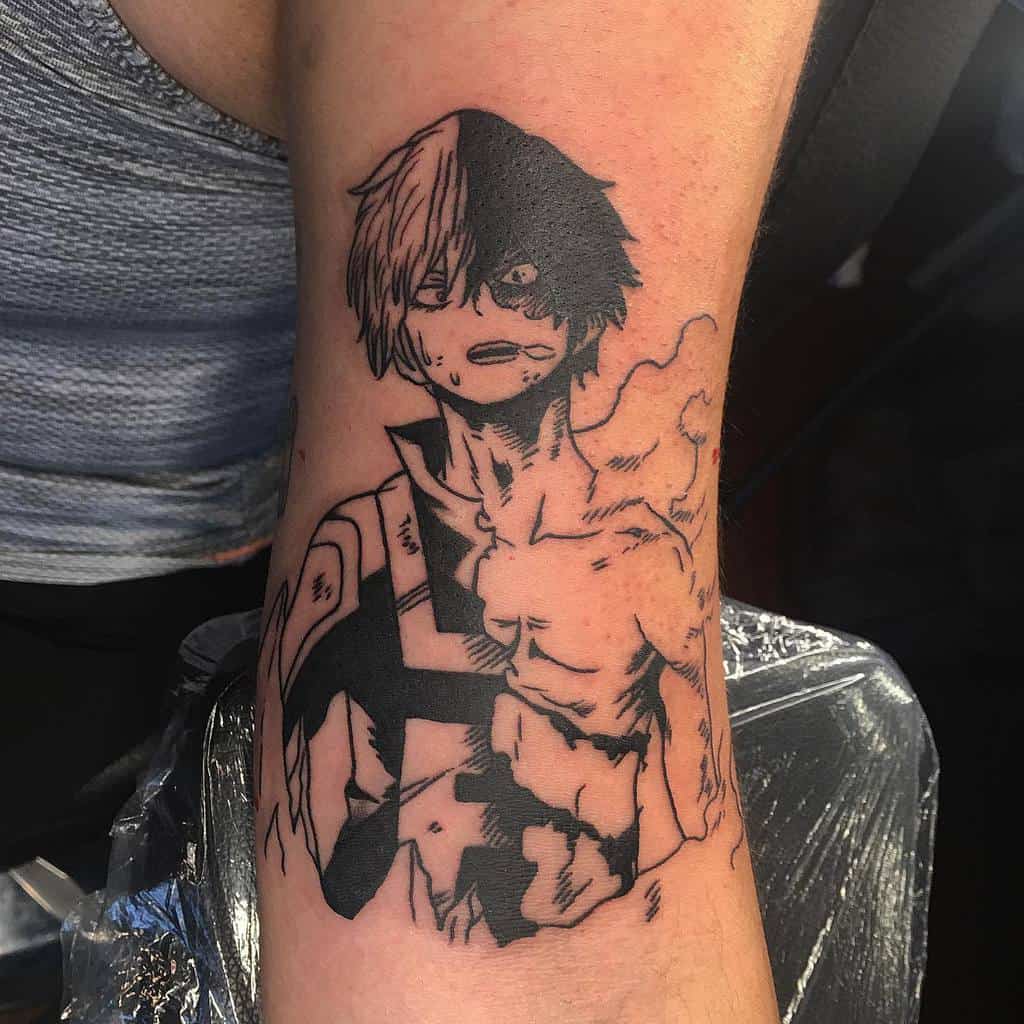 Black and grey tattoo of Shoto Todoroki from My Hero Academia, showcasing his intense expression, fire effect, and battle-worn hero costume