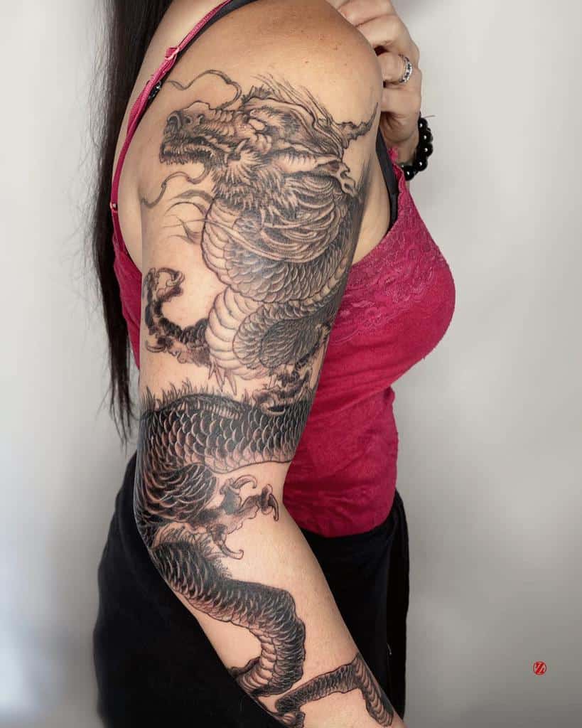 Woman with a detailed dragon tattoo on her arm
