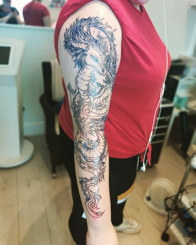 Woman with a detailed dragon tattoo on her right arm