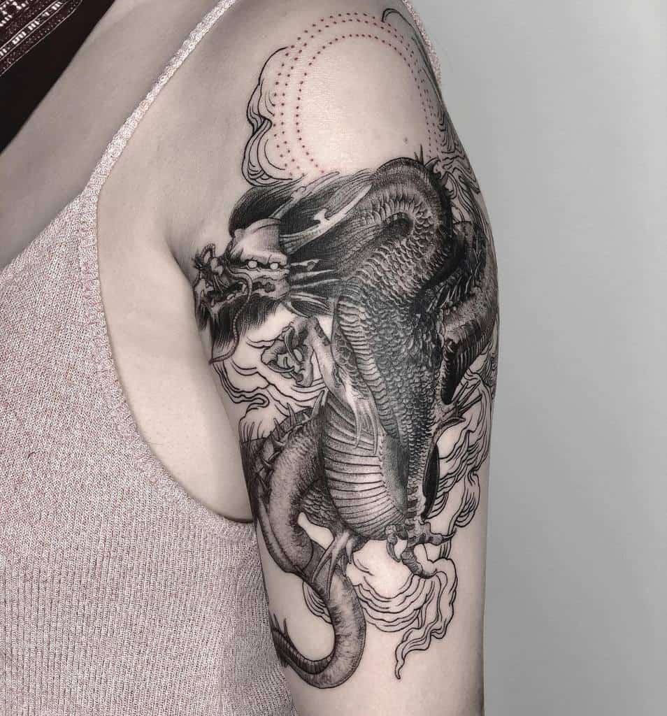 Tattoo of a detailed dragon on an her arm