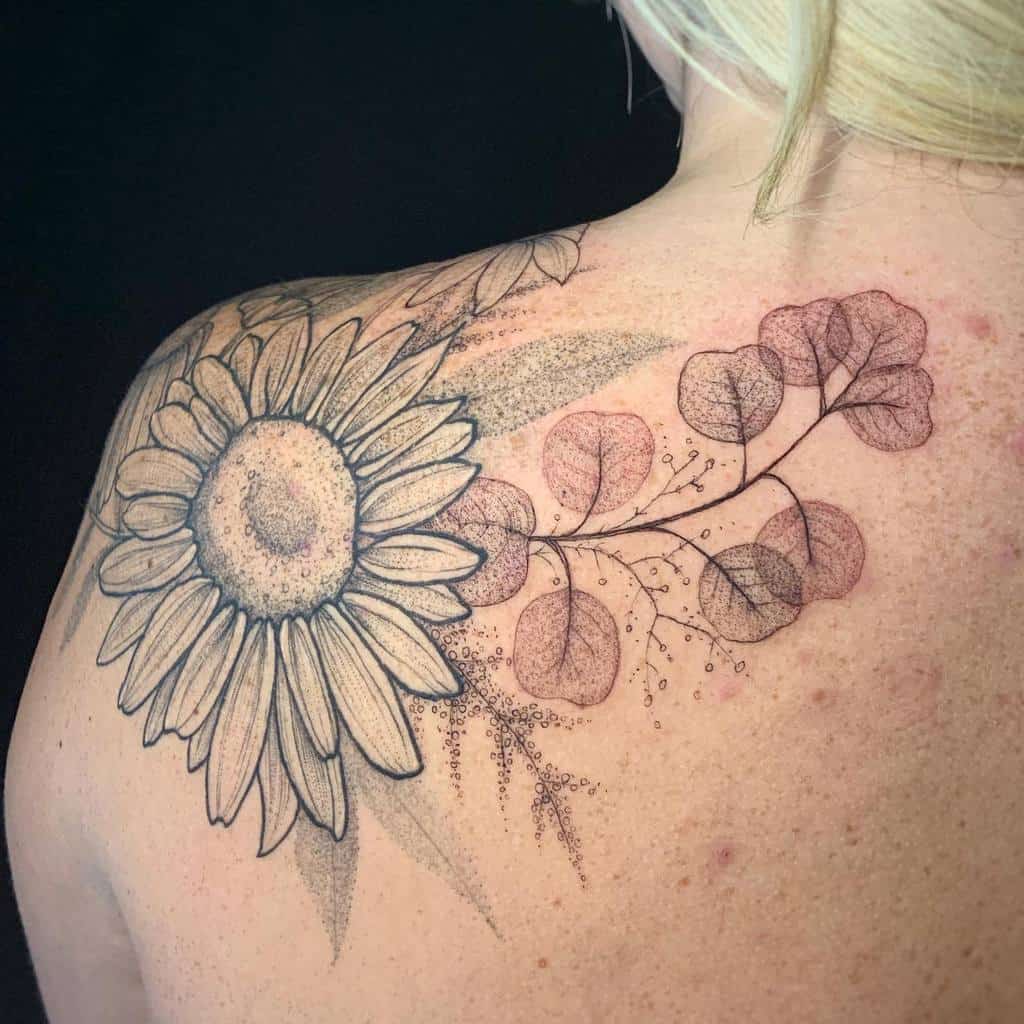 Sunflower, honeysuckle, and foliage tattoo on shoulder and upper back