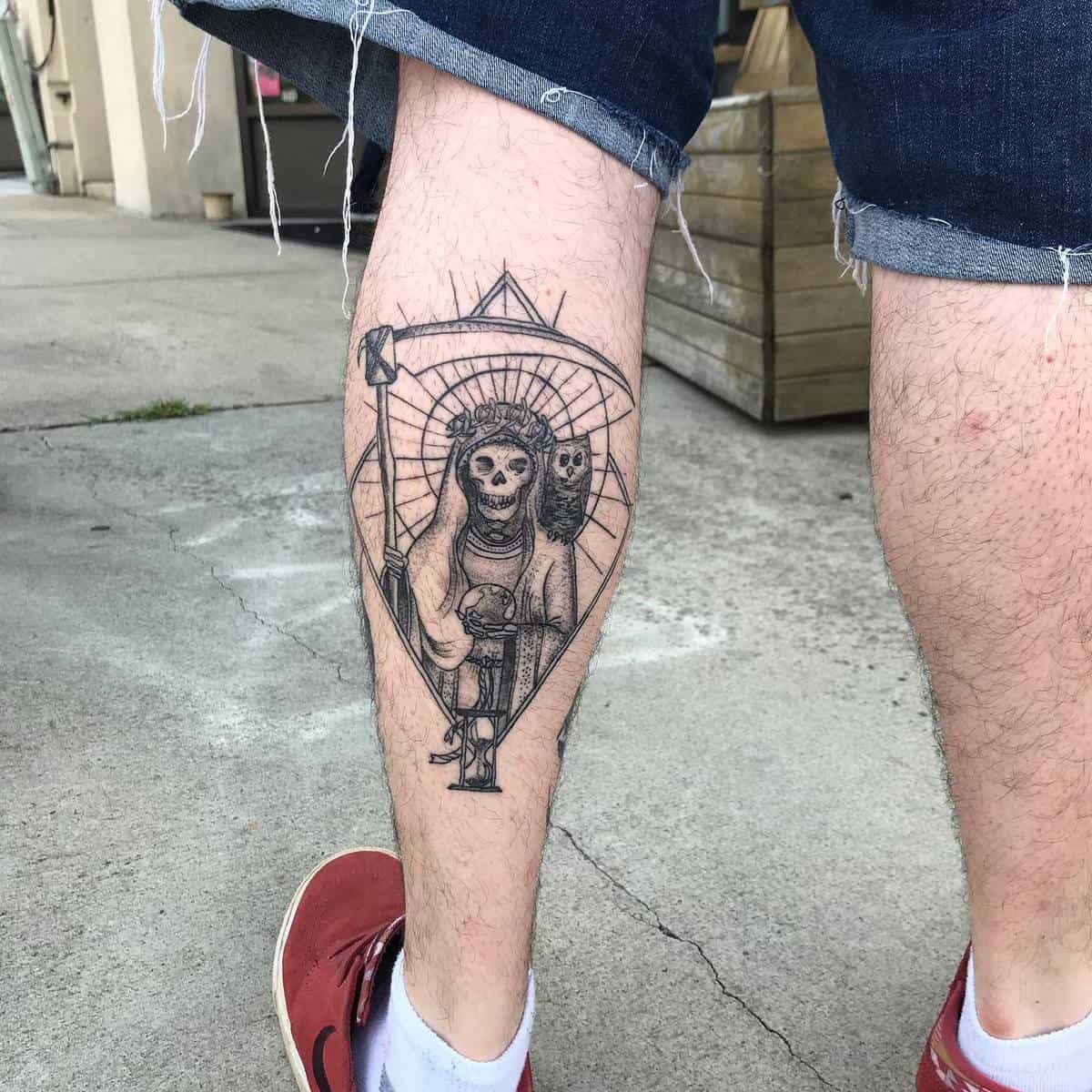 Santa Muerte tattoo on calf featuring detailed line work with a scythe and owl, symbolizing protection