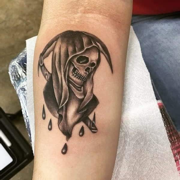 Santa Muerte tattoo with a hooded skull and dripping black drops, symbolizing death and protection