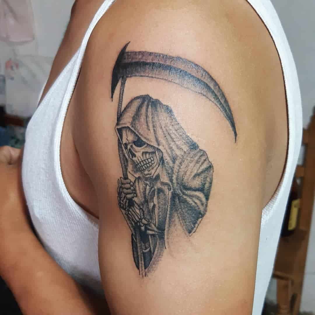 Santa Muerte tattoo featuring a skeleton in a hooded cloak holding a scythe, symbolizing protection and death