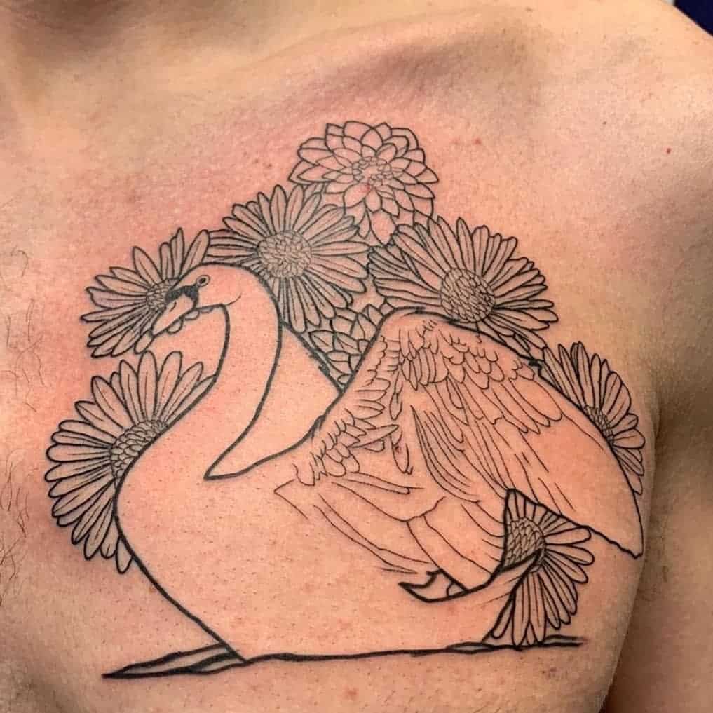 Black outline tattoo of a swan, daisies, and an aster on a chest