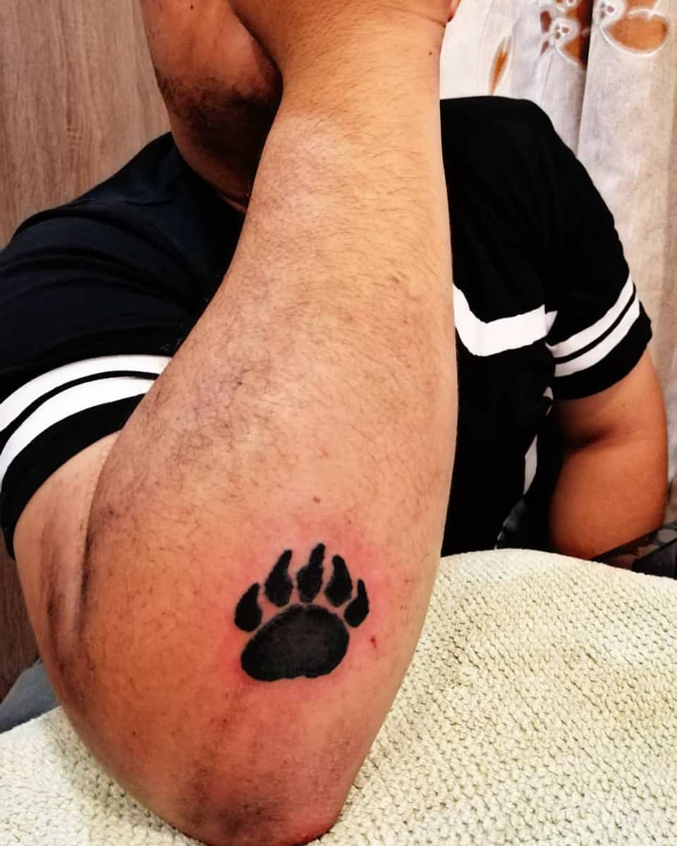 Bear paw tattoo on arm