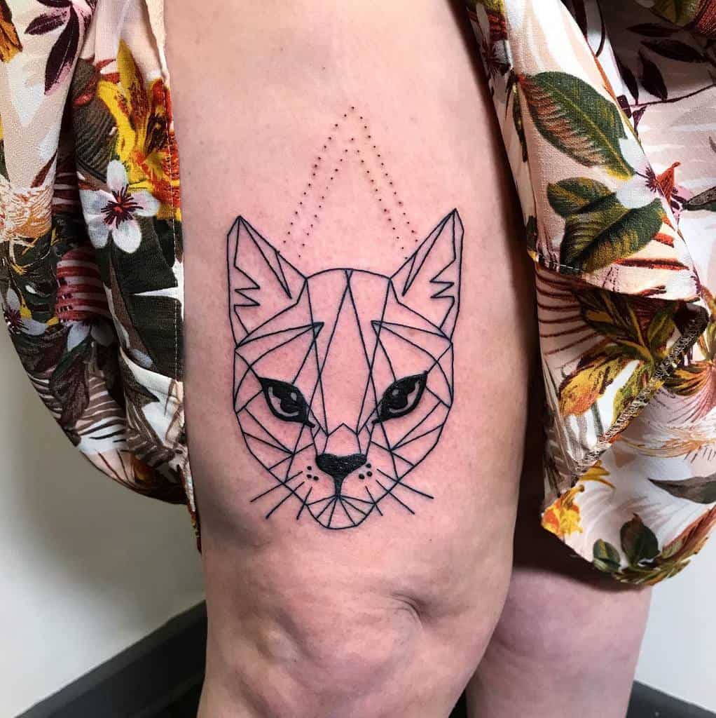 Geometric cat tattoo on a person's thigh