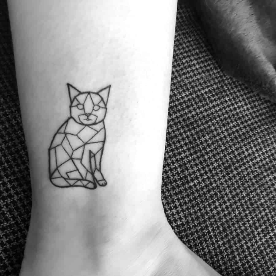 Geometric cat tattoo on a person's ankle, in black ink