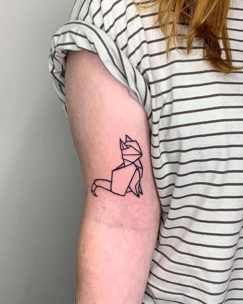 A geometric cat tattoo on an upper arm