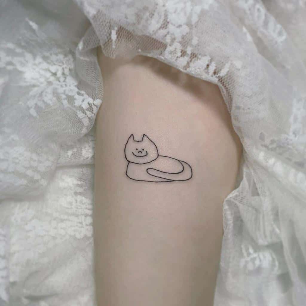 Simple cat line tattoo on an arm