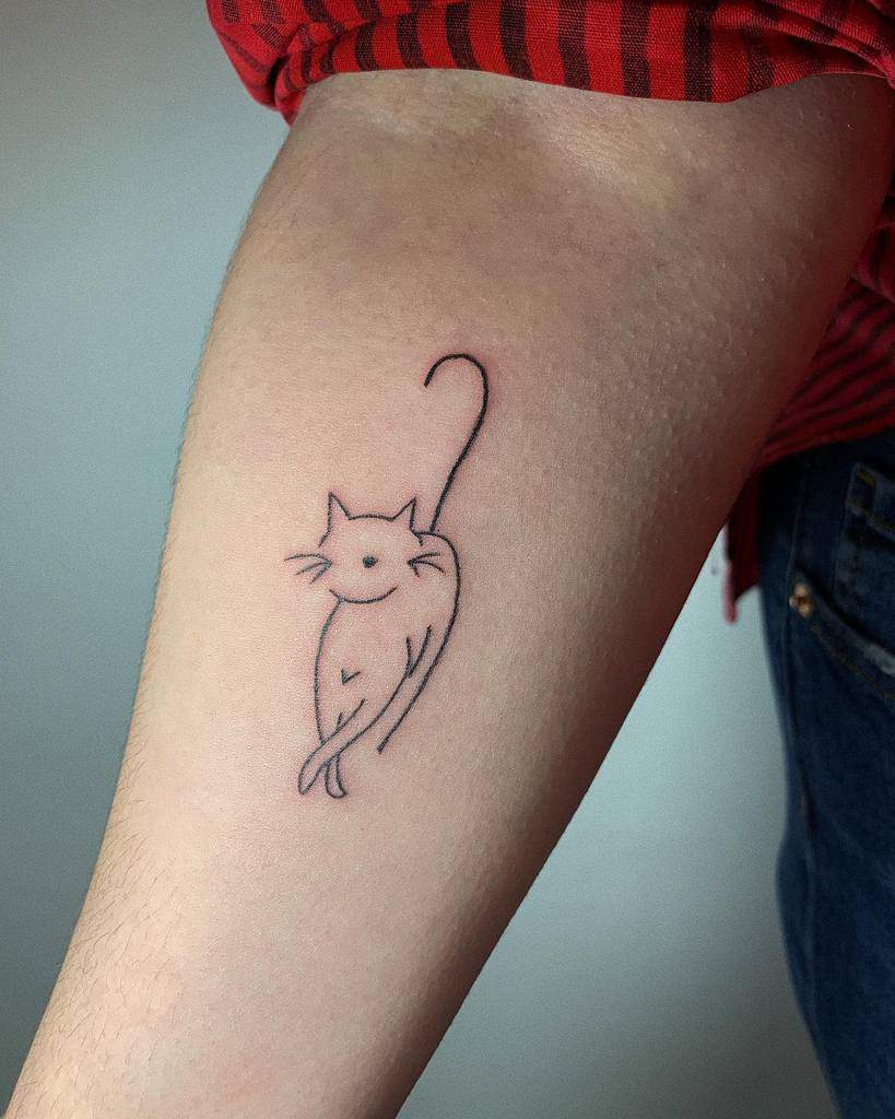 A simple black cat outline tattoo on a forearm