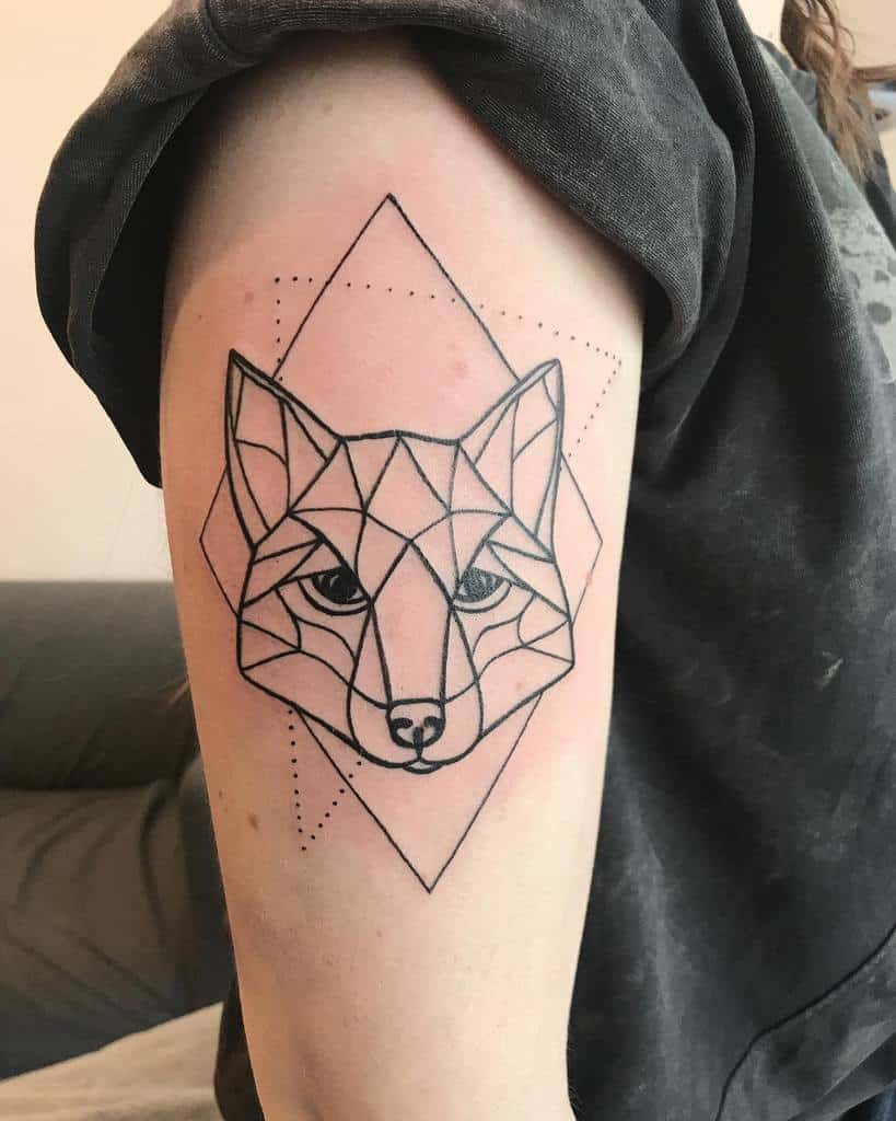 A geometric fox tattoo on the upper arm with precise lines and subtle shading