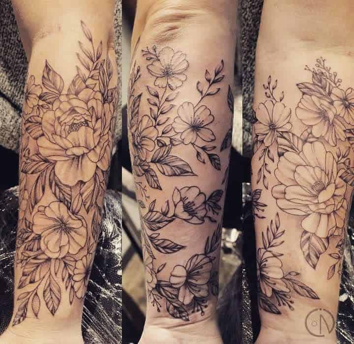 Black floral tattoo sleeves on the forearm