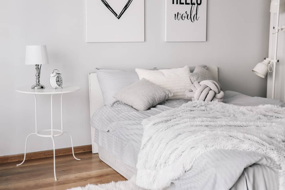 white bedroom with small bedside table