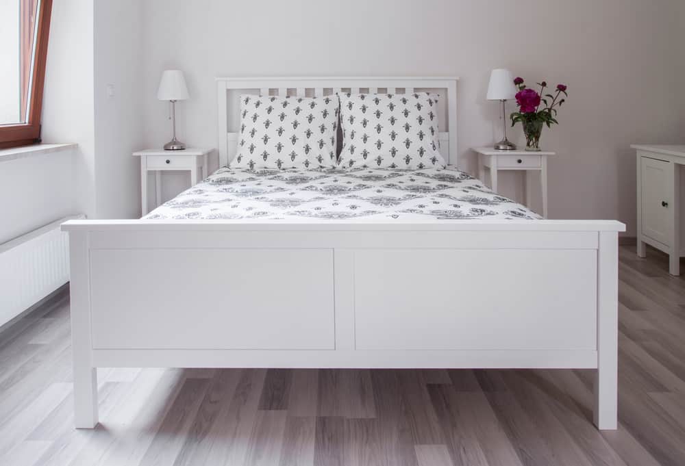 white bed frame in small bedroom