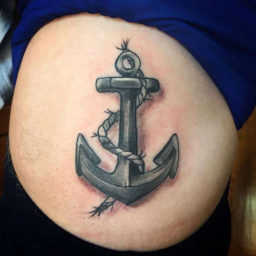 Tattoo of a shaded anchor with a rope wrapped around it on a person's arm, paying tribute to the navy's timeless heritage