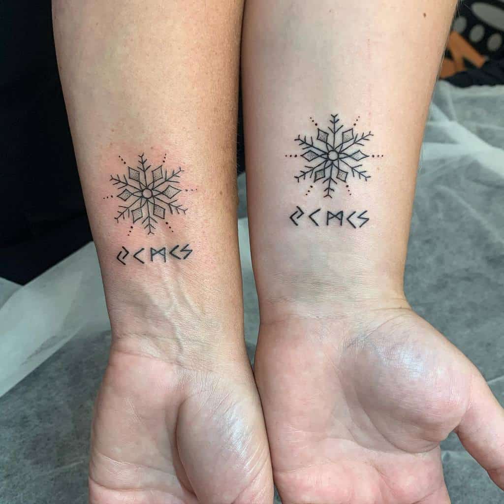Matching forearm tattoos featuring snowflake designs with runic-like symbols below, in a minimalist Nordic aesthetic style