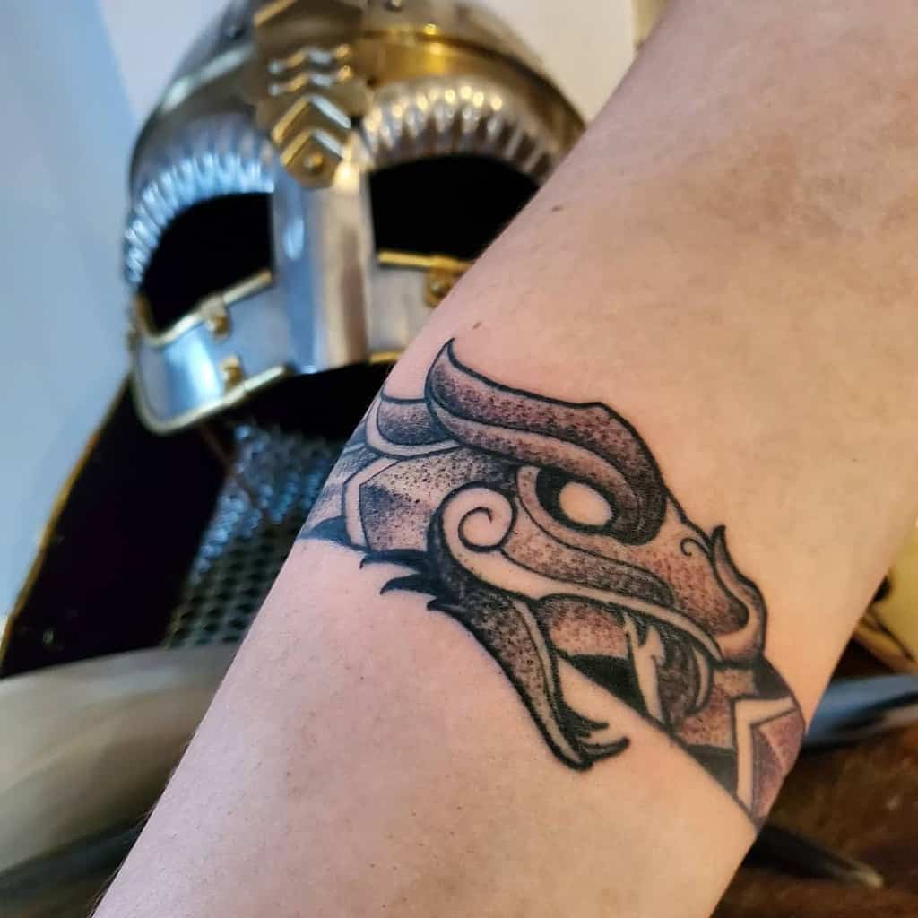 Simple Nordic dragon tattoo on the forearm with dotwork shading