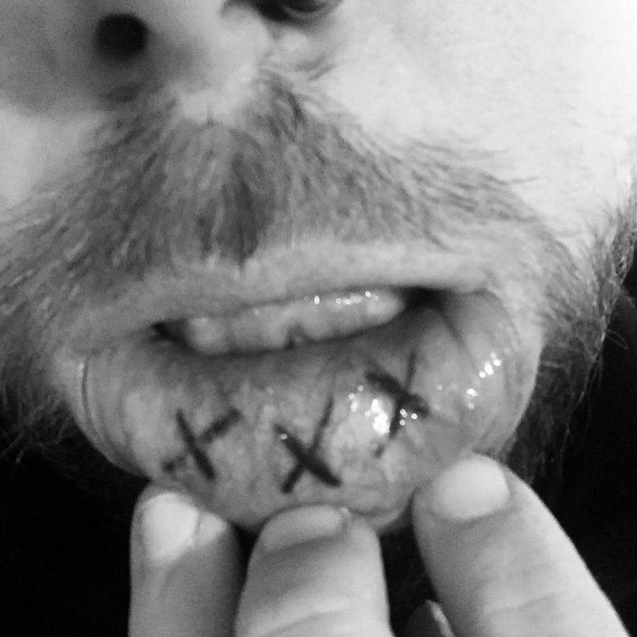 Inner lip tattoo for men featuring three bold black X symbols in a simple and edgy style.