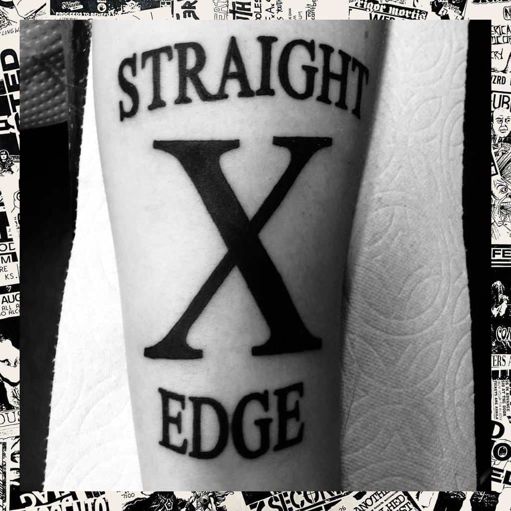 Black tattoo on skin with "Straight Edge" text and large X in the center