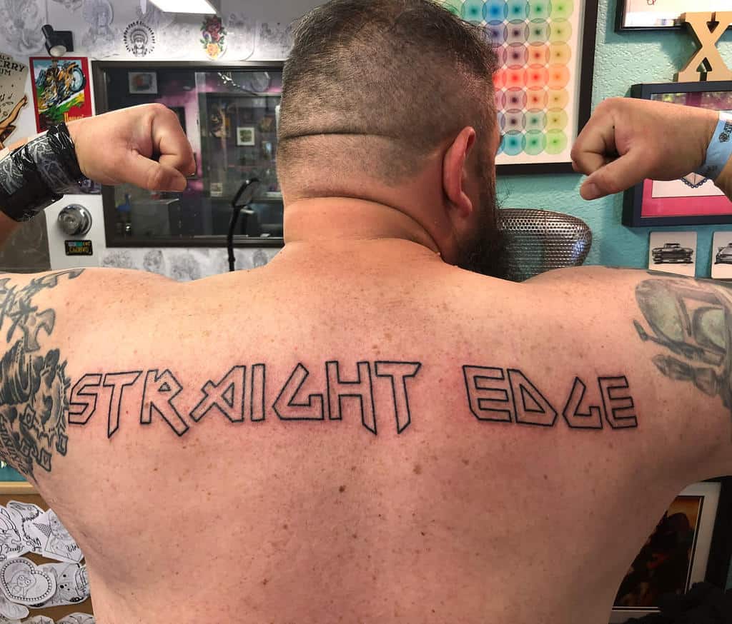 Straight edge tattoo in bold, angular outlined lettering, representing dedication to a clean lifestyle