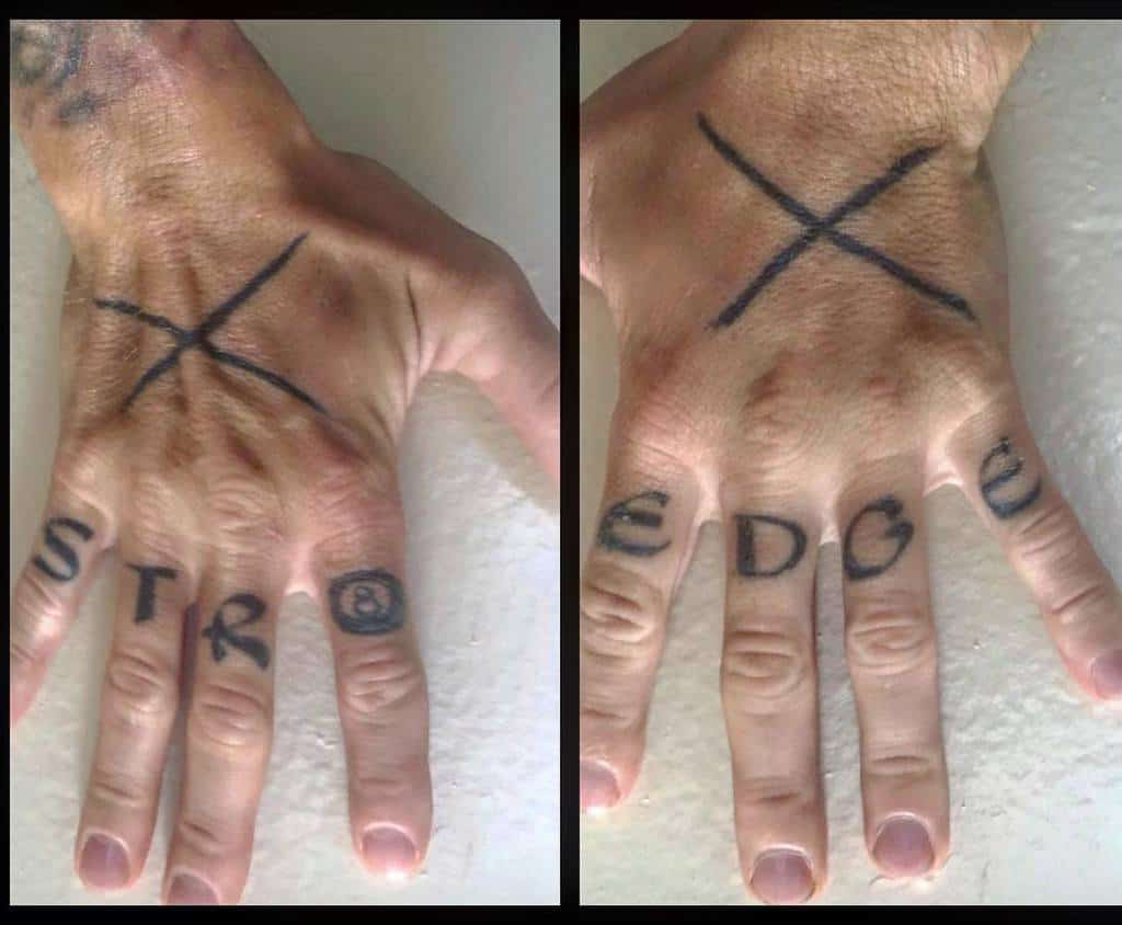 Straight edge hand tattoos with a bold 'X' on the back of each hand and 'STR' and 'EDGE' inked across the fingers