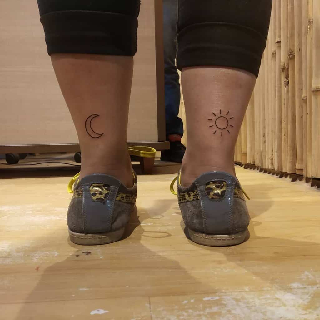 Two tattooed legs: moon on left, sun on right