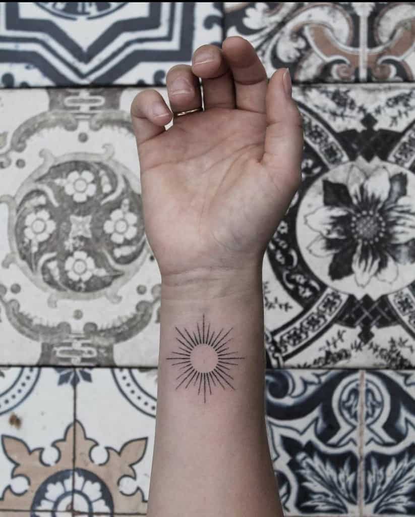 Simple Sun Wrist Tattoo