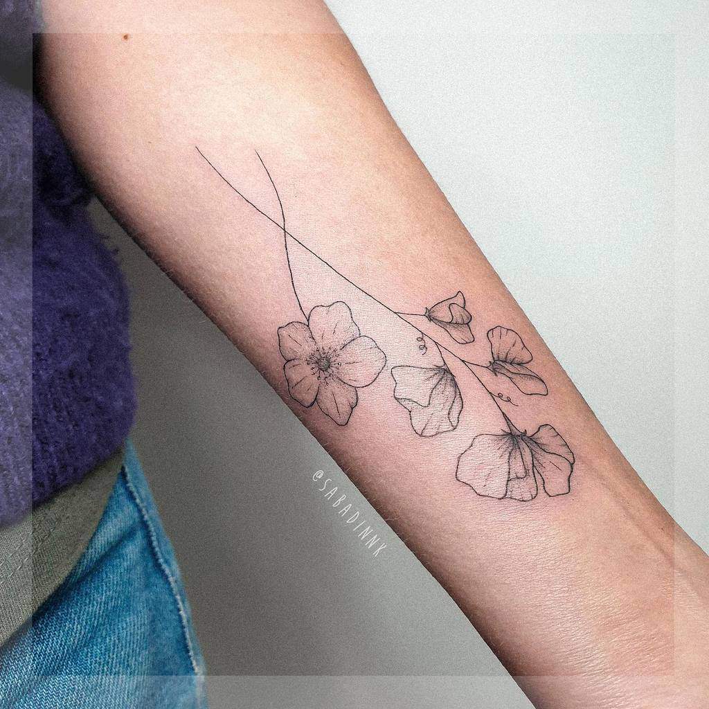 A fine-line tattoo combining sweet pea flowers with a large bloom, creating a soft, elegant design