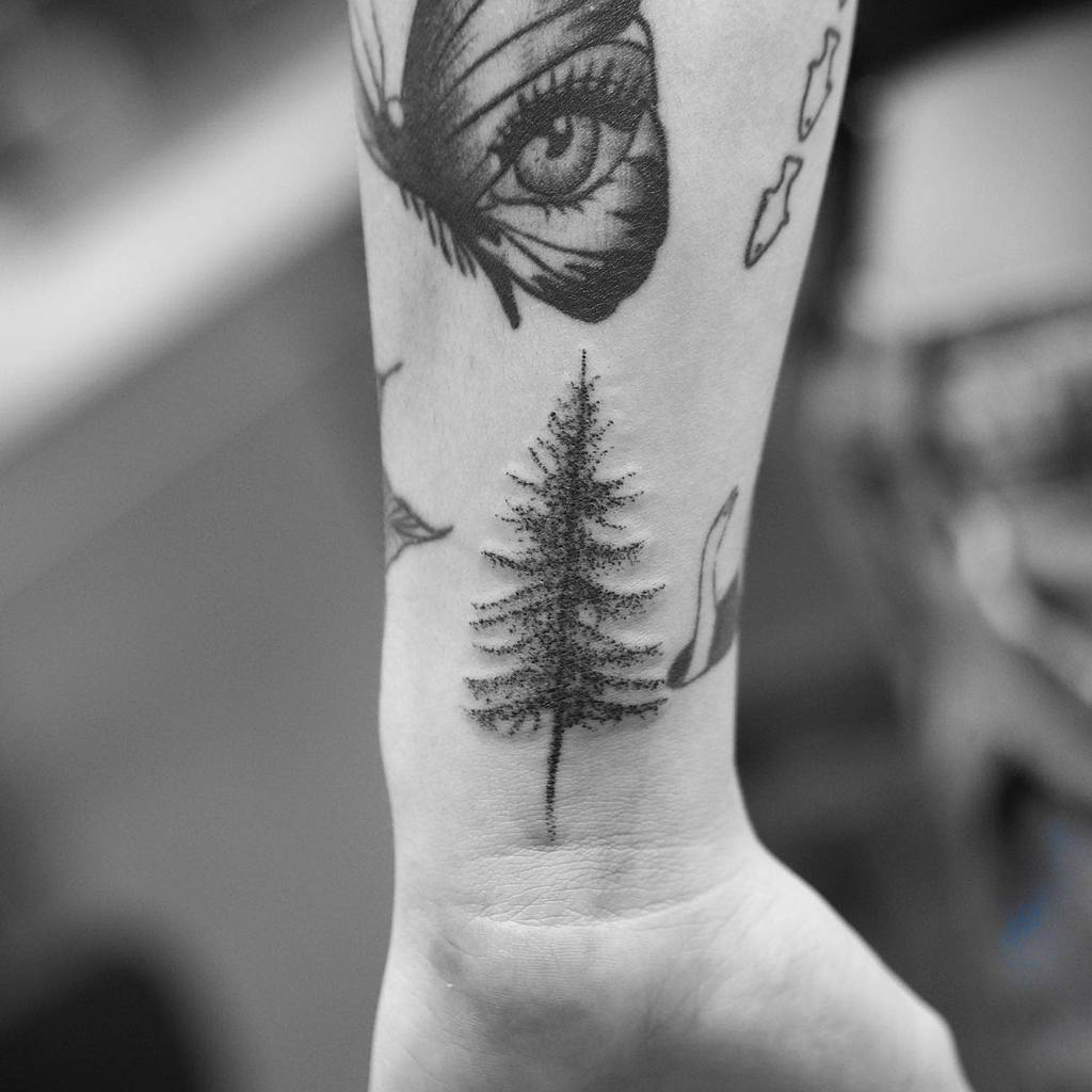 Forearm tattoo of a detailed tree