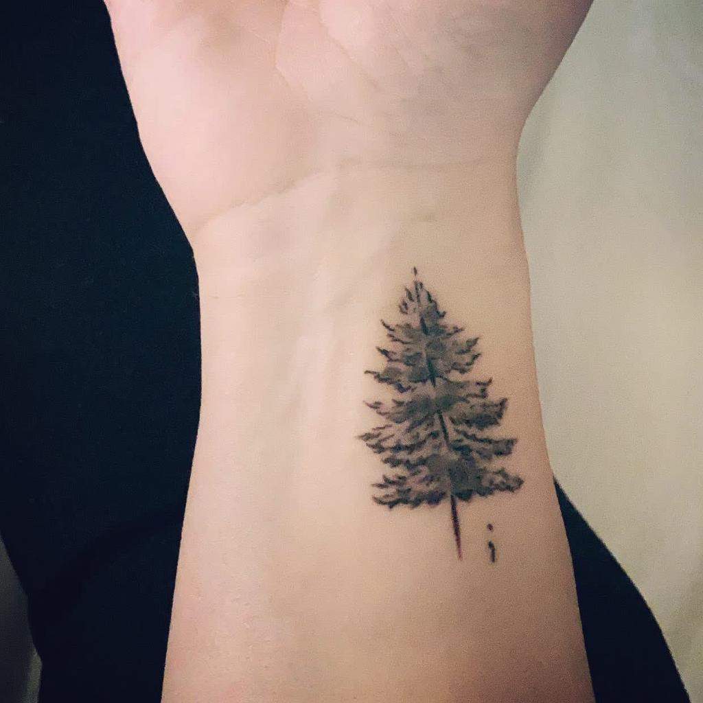 Simple tattoo of a tree on the wrist