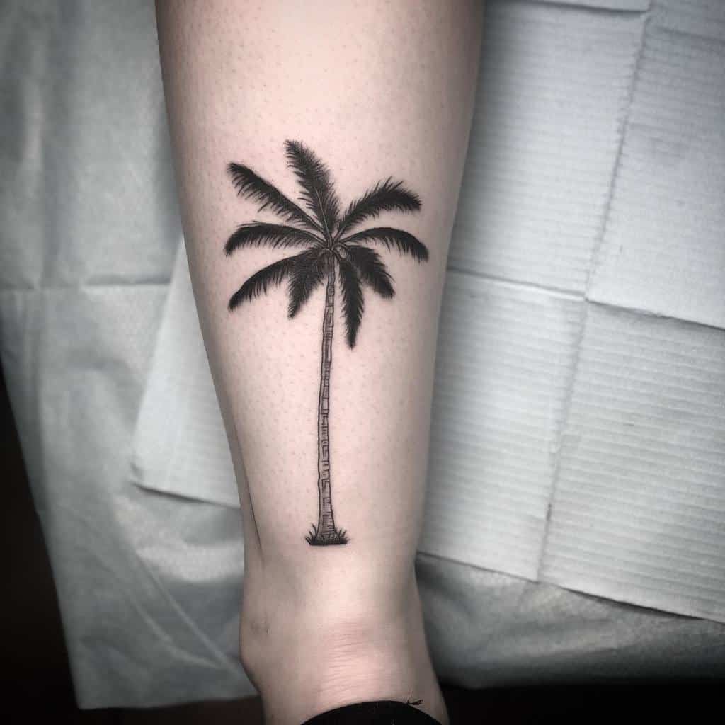 A silhouette tattoo of a palm tree on a forearm