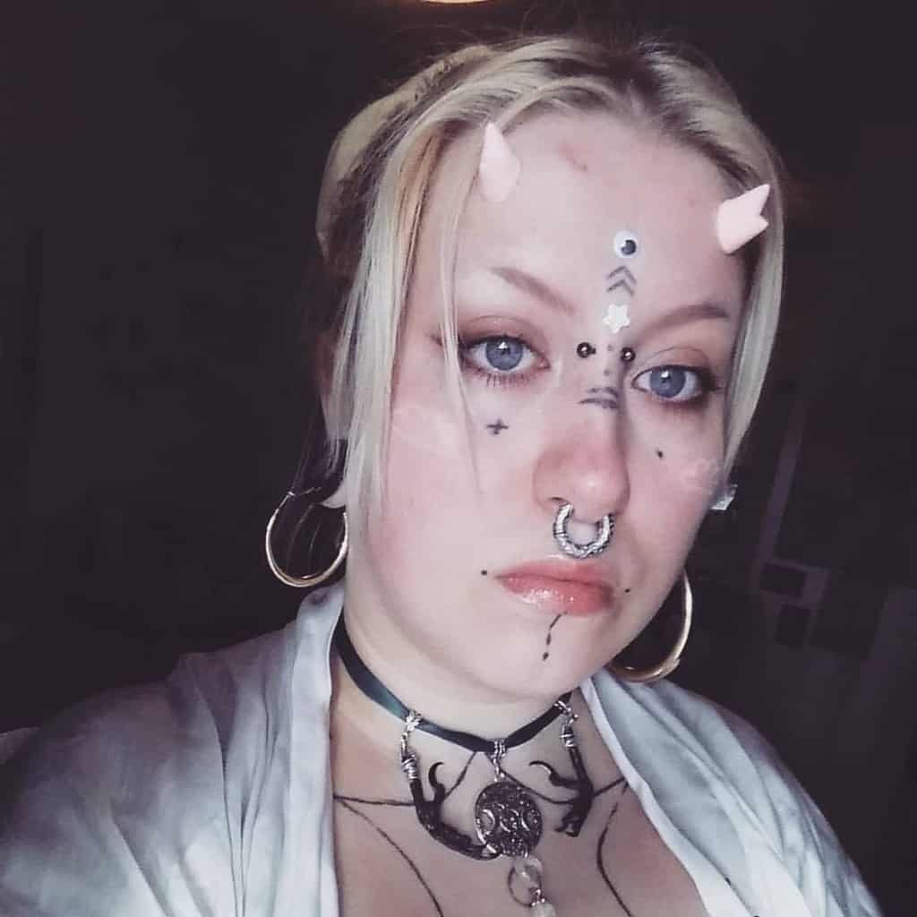 Woman with simple decorative face tattoos