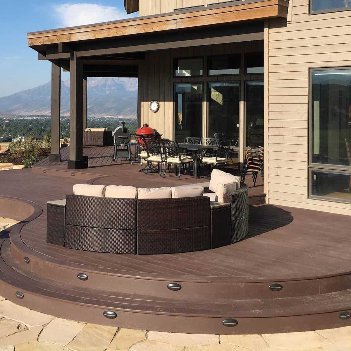 large wood deck bbq wicker furniture mountain views