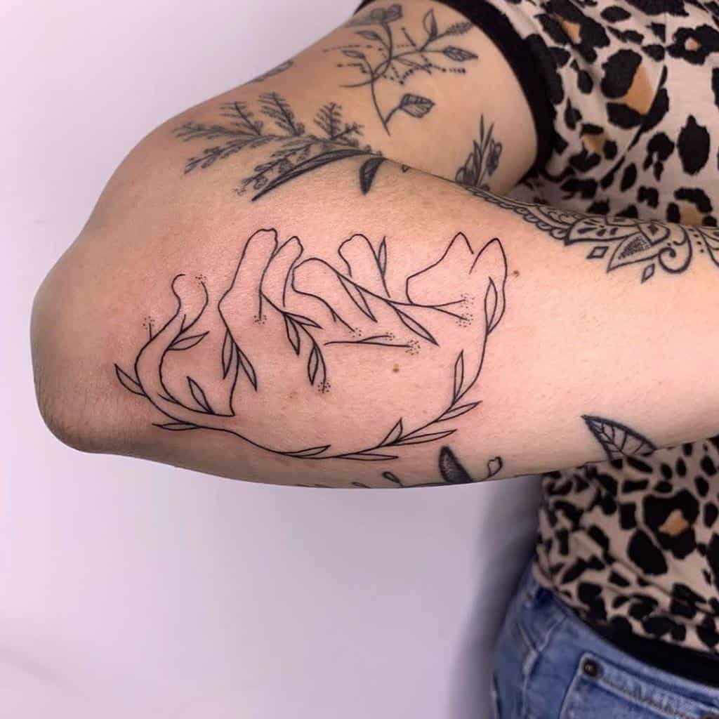 Outline tattoo of a sleeping cat