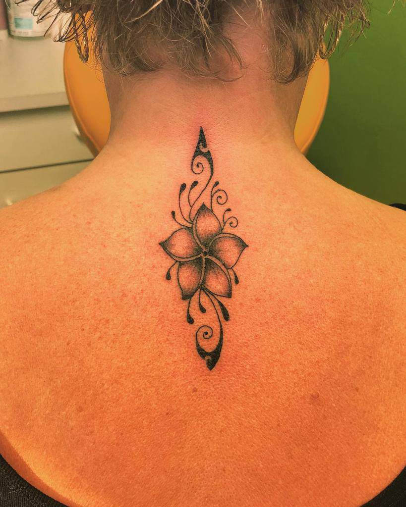 Neck tattoo featuring an ornamental floral design with swirling details