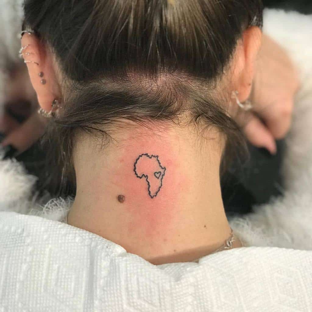 Outline tattoo of Africa with a heart on the right, located on the back of neck