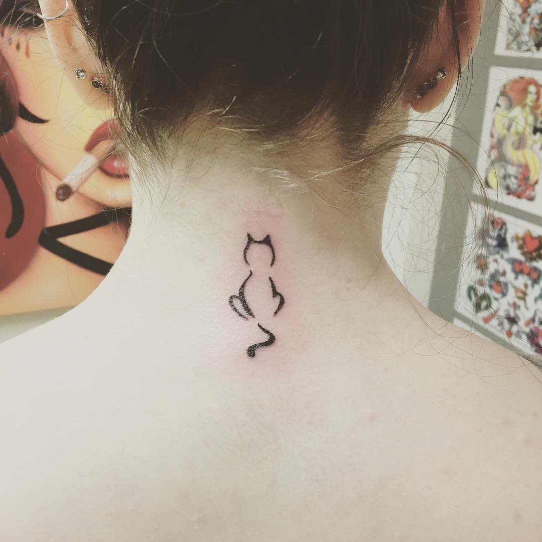 Simple cat outline tattooed on the back of neck