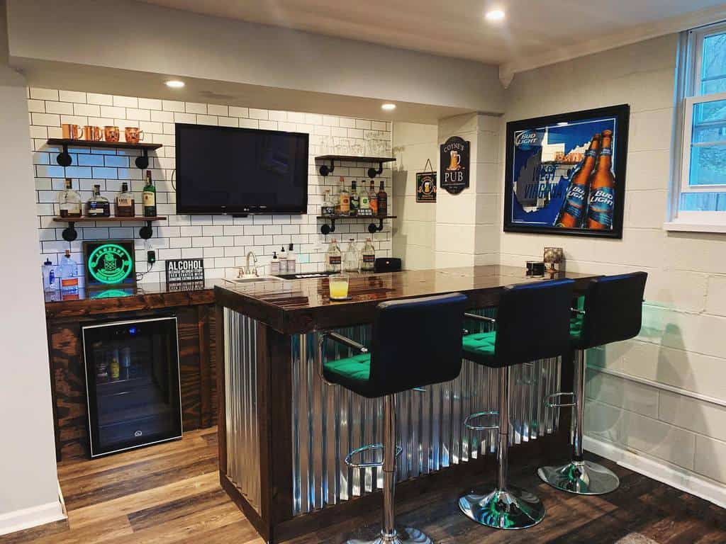 Small basement bar with corrugated metal panels, subway tile backsplash, and black bar stools.