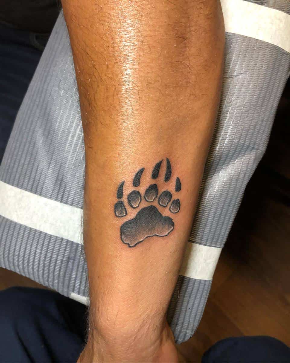 A bear paw tattoo on a person's forearm