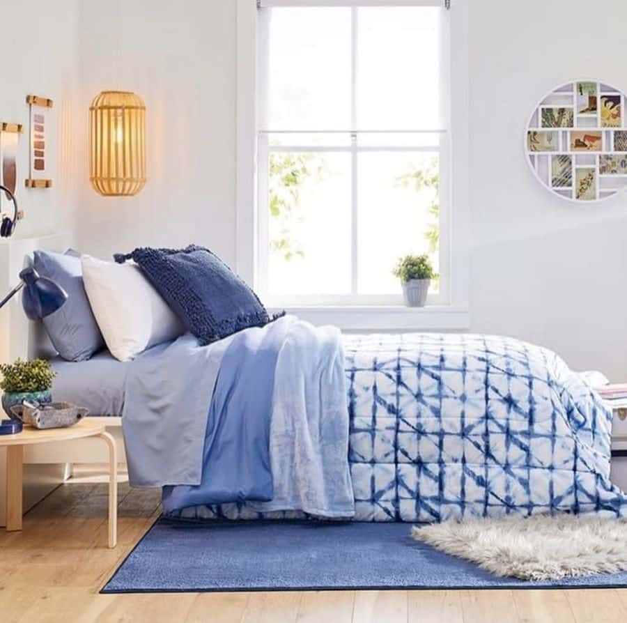 blue bed in small white bedroom