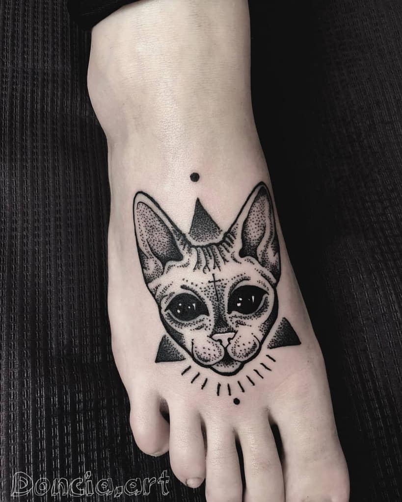 Cat tattoo on a foot, featuring geometric shapes and dotwork design