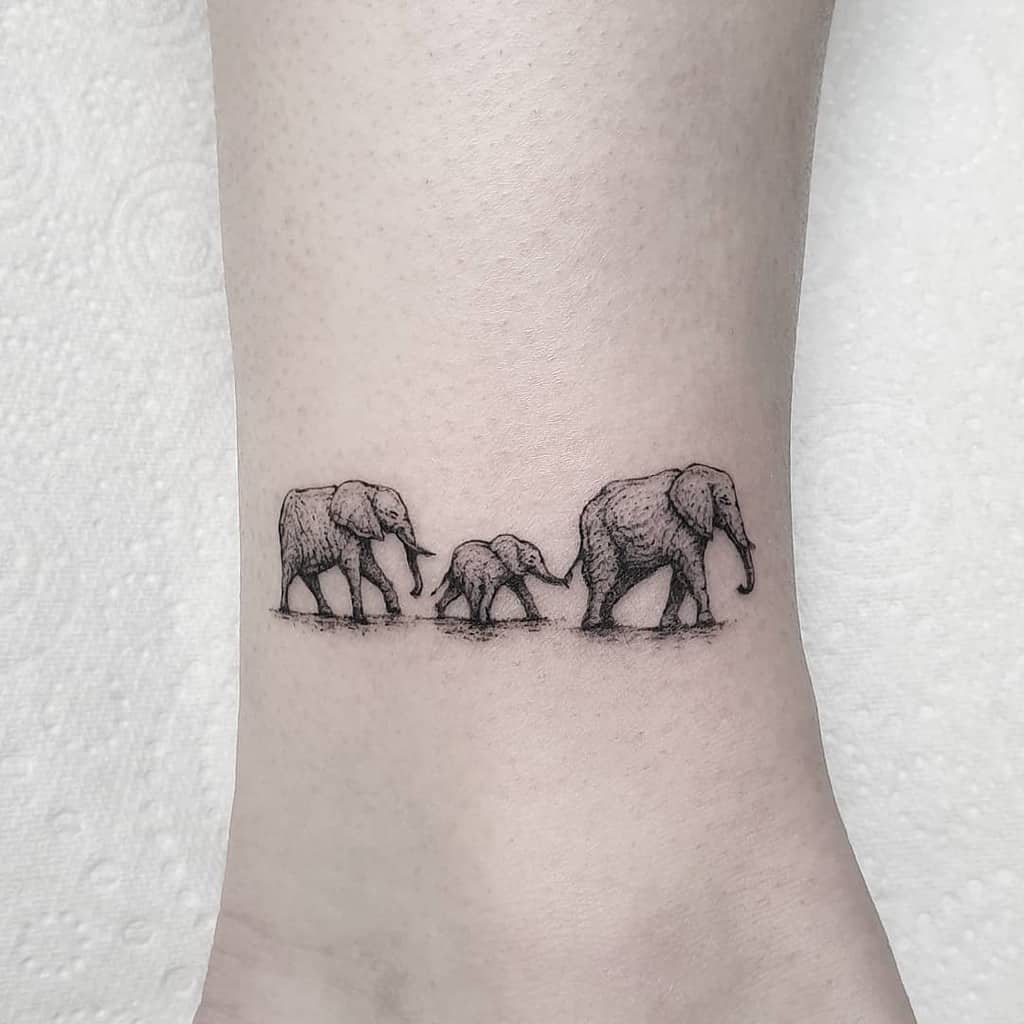 Tattoo of three elephants walking in a line