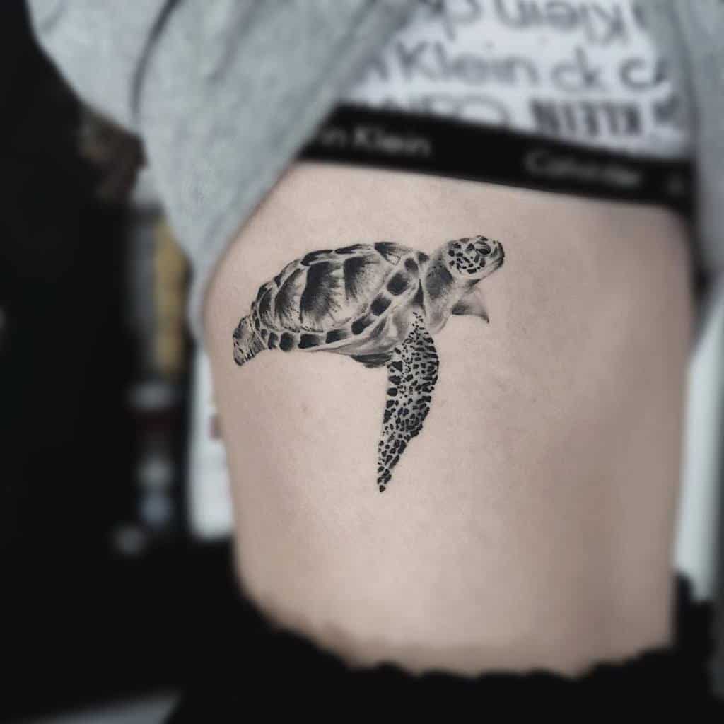 Tattoo of a sea turtle on a person's side