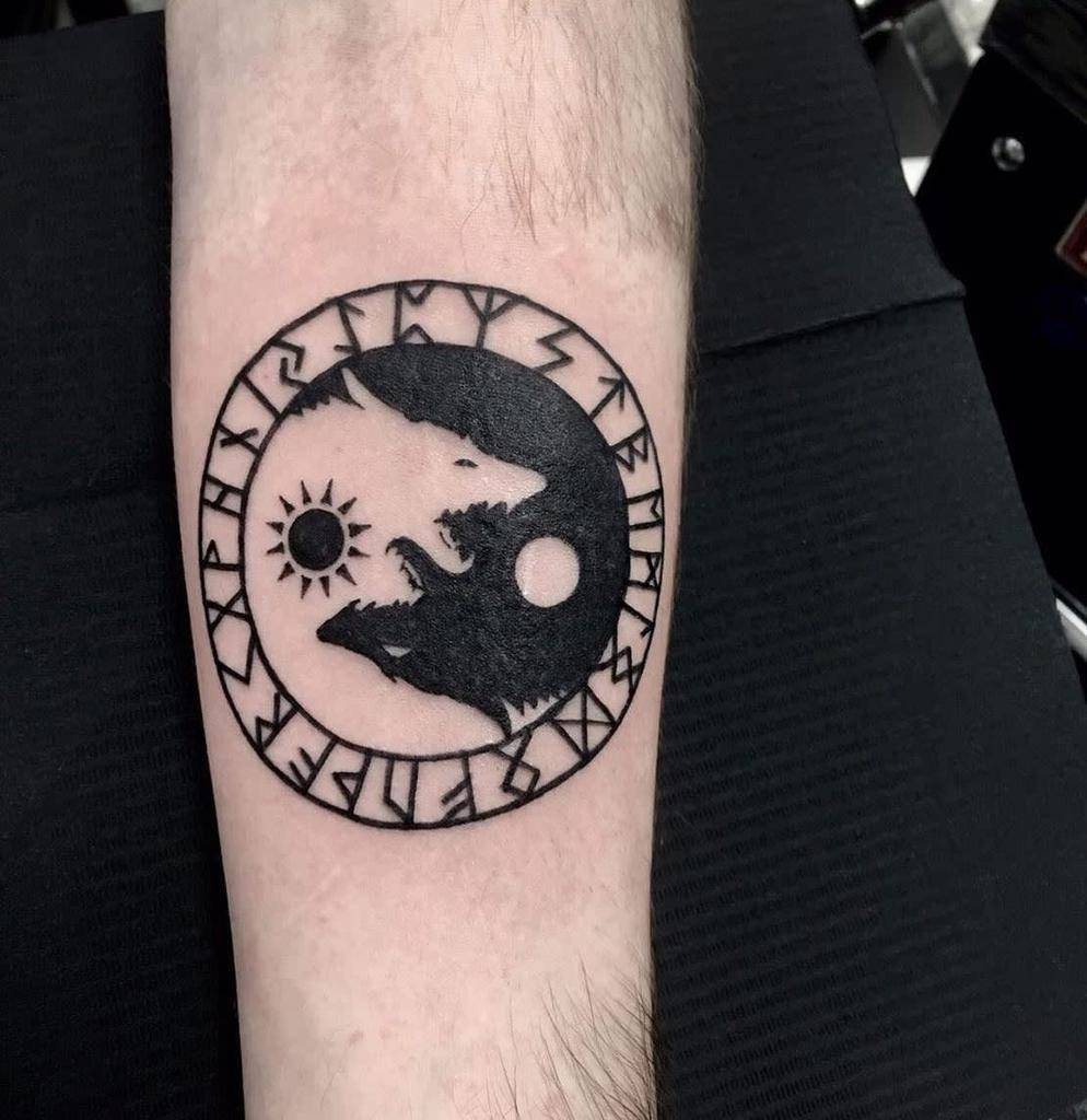 Black and white wolf yin-yang tattoo with Norse runes encircling the design, symbolizing balance and duality